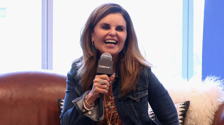 Maria Shriver holding a microphone