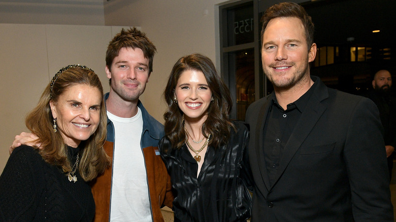 Maria Shriver, Patrick Schwarzenegger, Katherine Schwarzenegger, and Chris Pratt smile