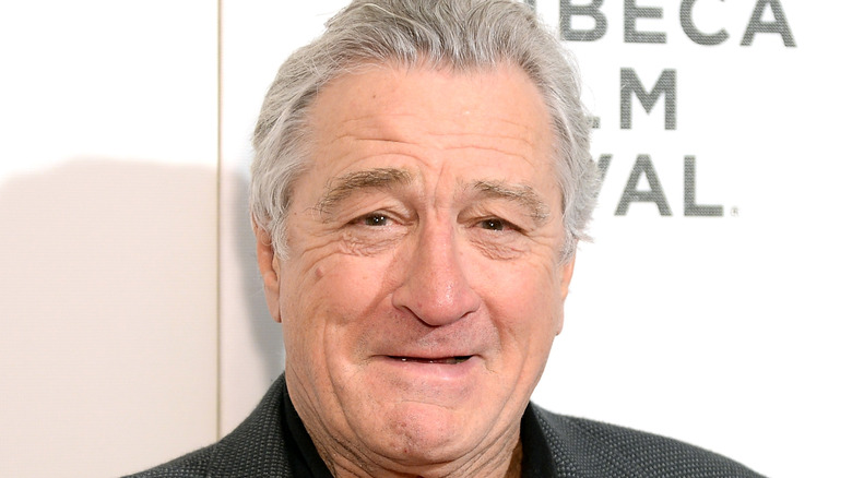 Robert De Niro smiles at an event