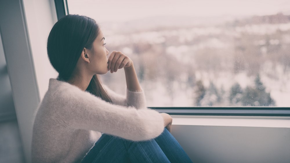 Woman looking out a window