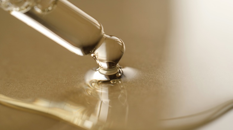 A skincare dropper on a table