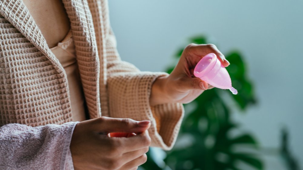 Woman holding a menstrual cup 