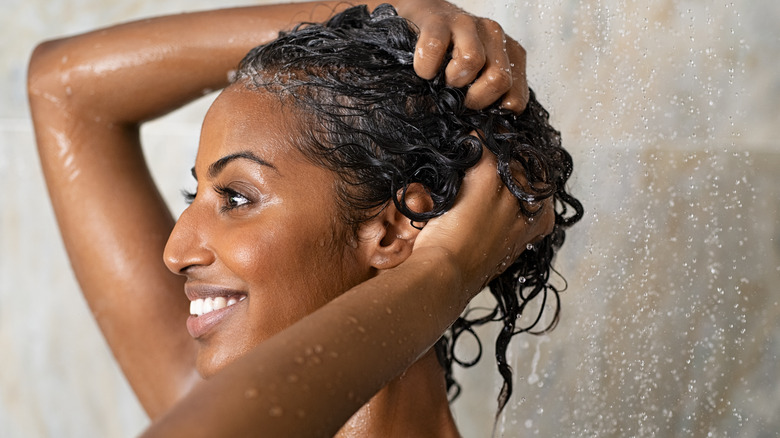 Woman washing hair in shower