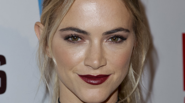 Emily Wickersham smiling on a CBS carpet