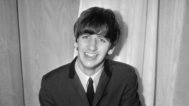 Old black and white glamor shot of Ringo Starr from The Beatles smiling in 1963
