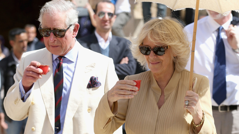 King Charles III and Queen Camilla enjoying drinks