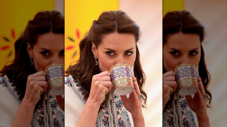Princess Catherine glancing at the camera over her muf=g