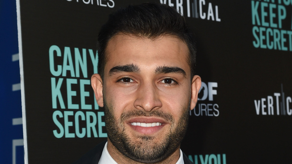 Sam Asghari smiling at event