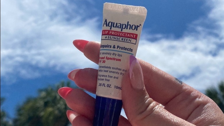 Aquaphor lip repair in hand outside