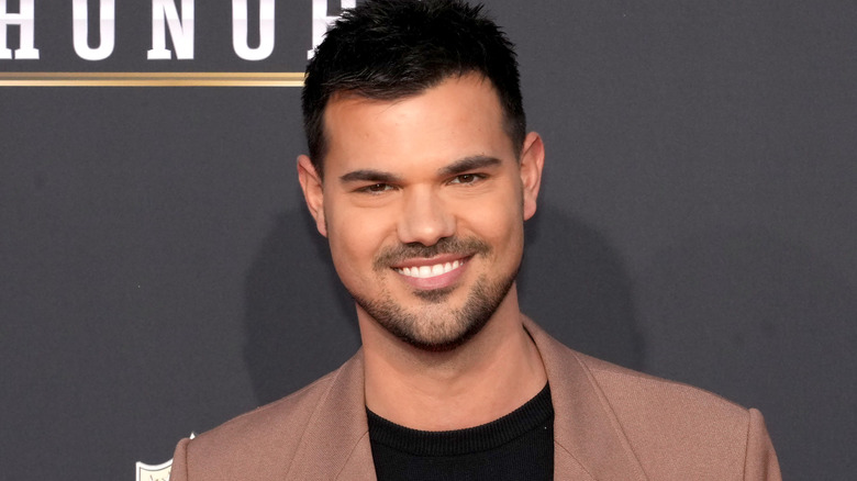 Taylor Lautner smiling at the camera