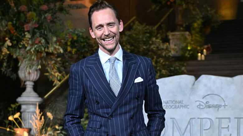 Tom Hiddleston laughing at the camera