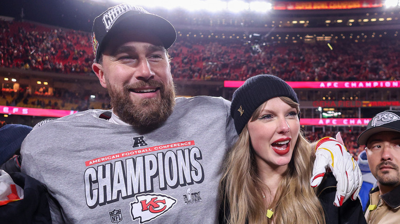 Taylor Swift and Travis Kelce embracing on a football field