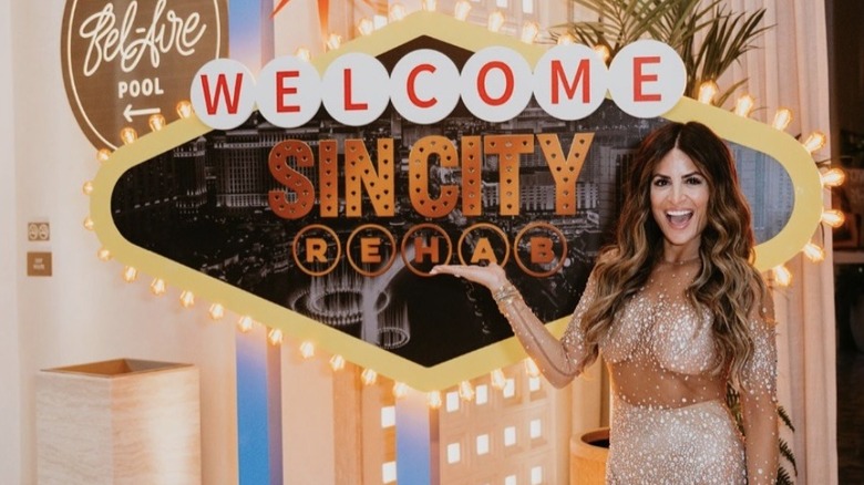 Alison Victoria posing with Sin City Rehab logo