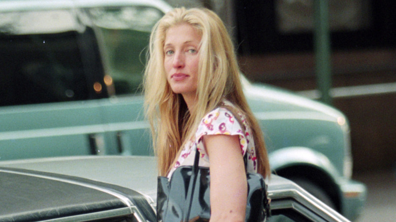 Carolyn Bessette-Kennedy standing on street looking behind her