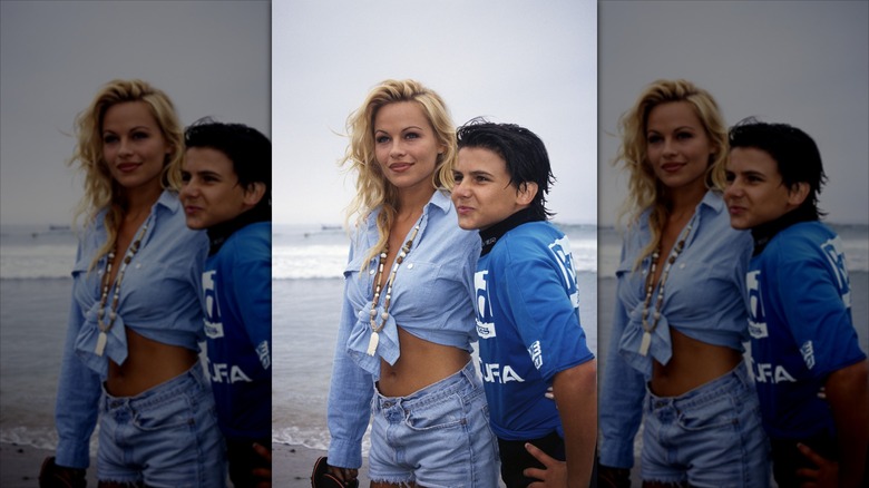Pamela Anderson and Jeremy Jackson smiling on a beach together.