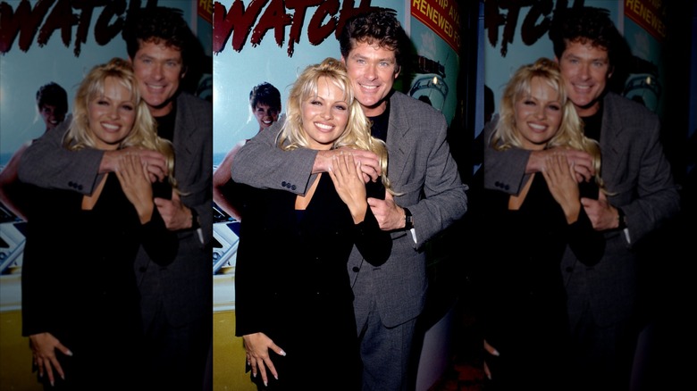 David Hasselhoff smiling with his arm around an also smiling Pamela Anderson.
