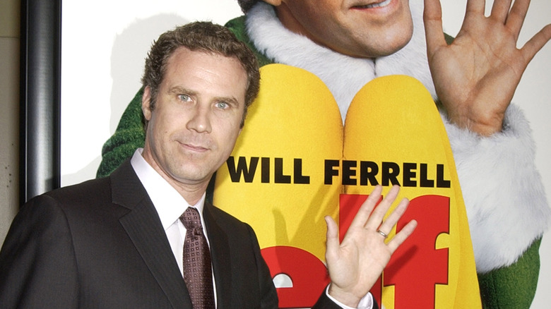 Will Ferrell next to the "Elf" poster 