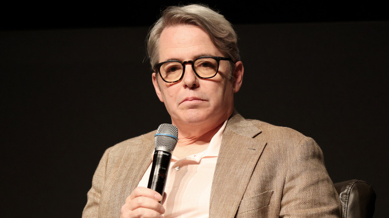 Matthew Broderick holding a microphone