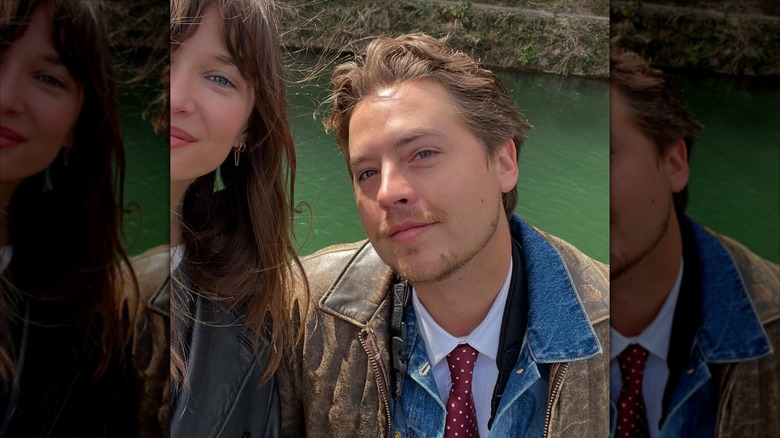 Cole Sprouse with his head tilted beside Ari Fournier