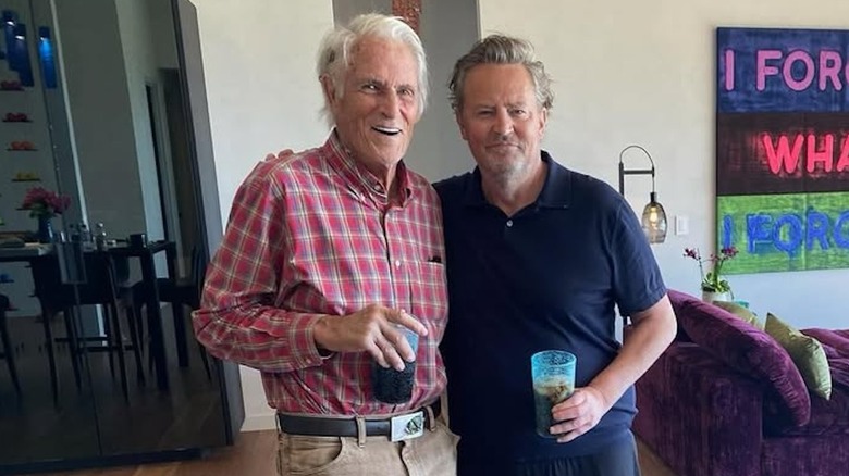 Matthew Perry and his father John Bennett Perry holding drinks inside Perry's house.