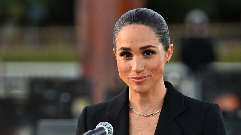 Meghan Markle speaking at a microphone