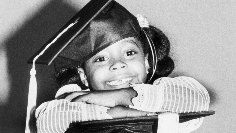 Young Keshia Knight Pulliam wearing graduation cap