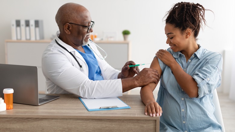 Pregnant woman getting vaccinated