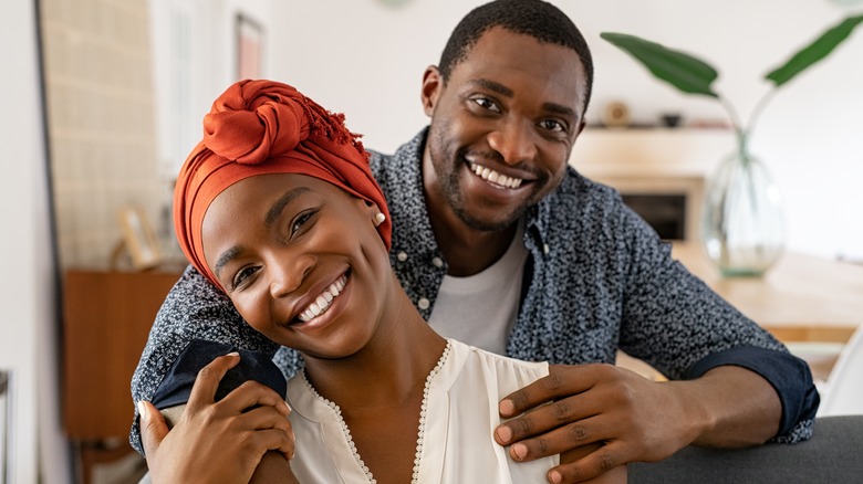 Black couple smiling at camera