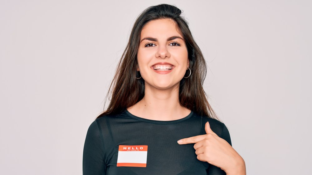 Woman pointing at name tag