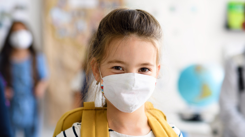 Girl wearing mask and backpack