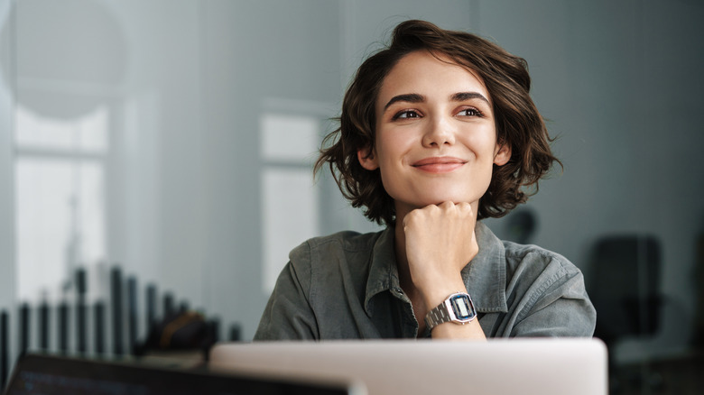 Happy woman working on laptop 