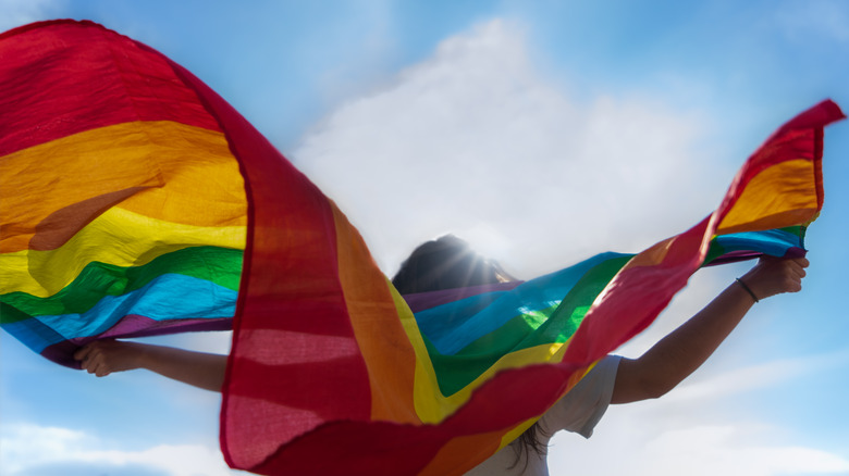 Woman holding a gay pride flag