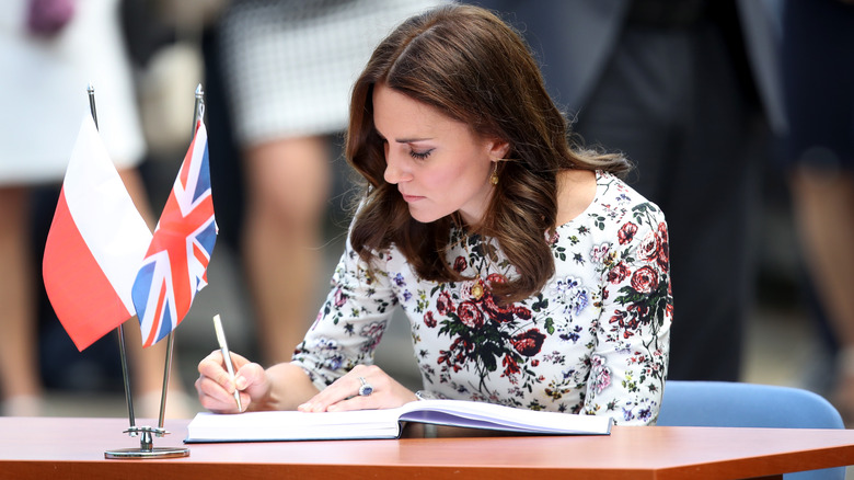 Princess Catherine writing in book