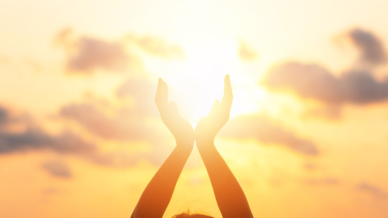 Two hands cupping the sun 