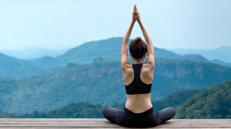 Woman doing yoga outdoors.