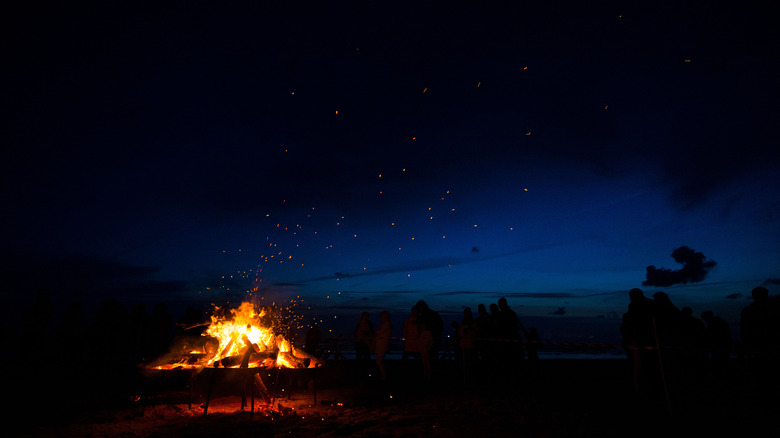 Image of person celebrating the summer solstice with bonfire