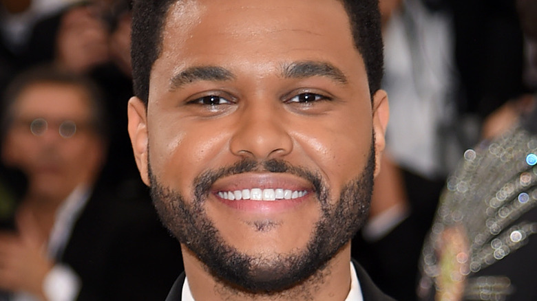 The Weeknd smiling at an event