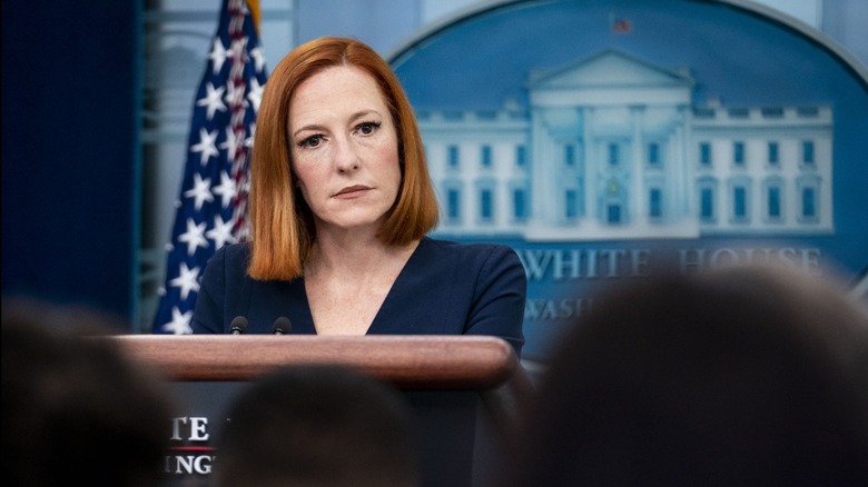 Jen Psaki standing at the podium in the White House briefing room