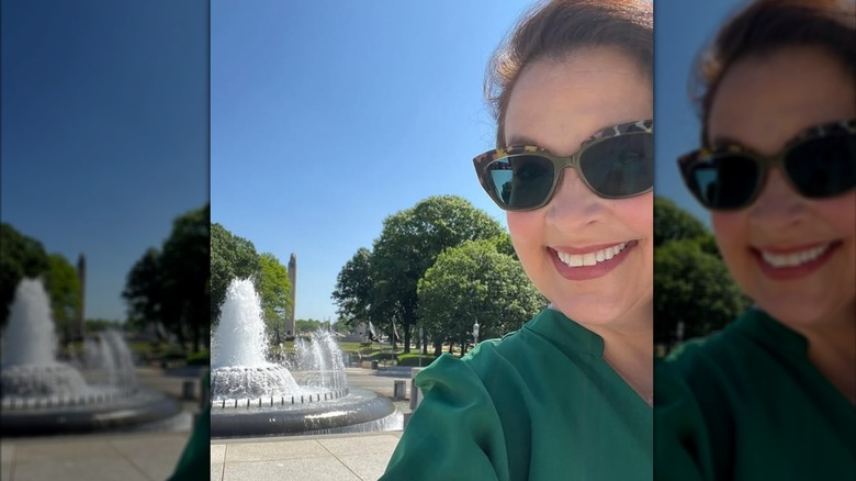 Jacque Gonzales poses for a selfie by a fountain in Harrisburg