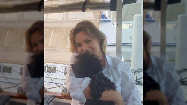 Lisa Robertson poses with her dog for an Instagram photo