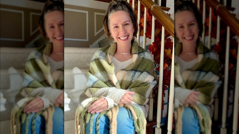 Sharon Faetsch poses on a staircase in her home
