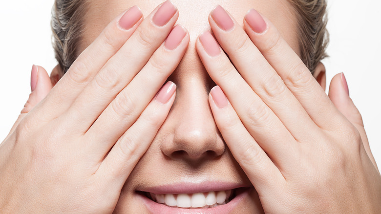 Woman with nails on face