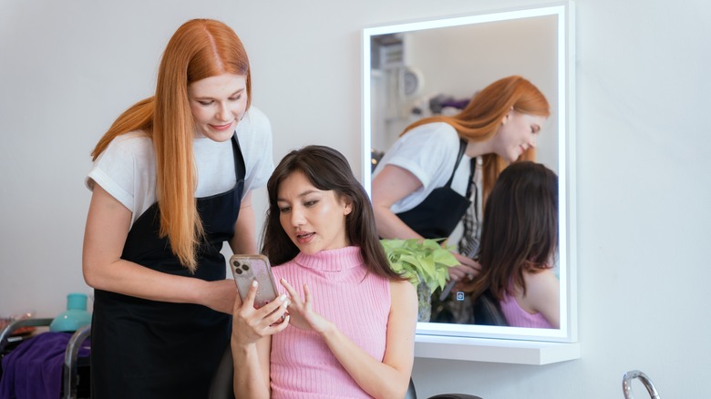 Client shows hair stylist pictures