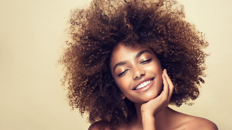 Woman with curly afro smiling