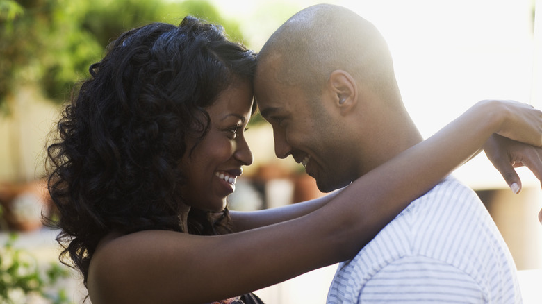 smiling couple gazing and hugging