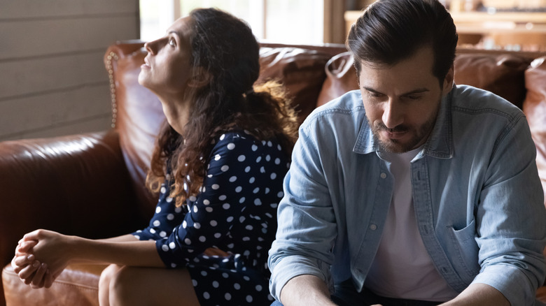 Couple on couch not communicating