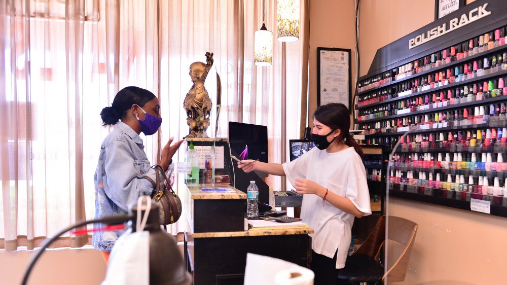 Client at a nail salon counter 