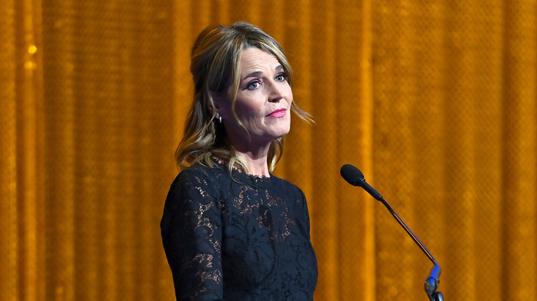 Savannah Guthrie addressing a crowd while accepting an award behind the podium