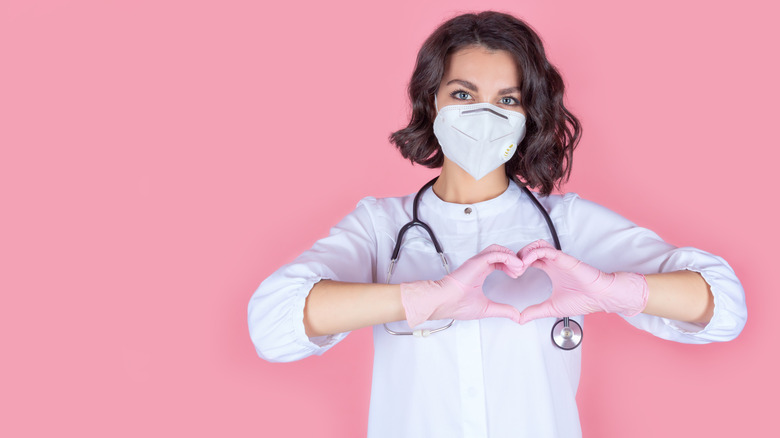 Female doctor making hand heart