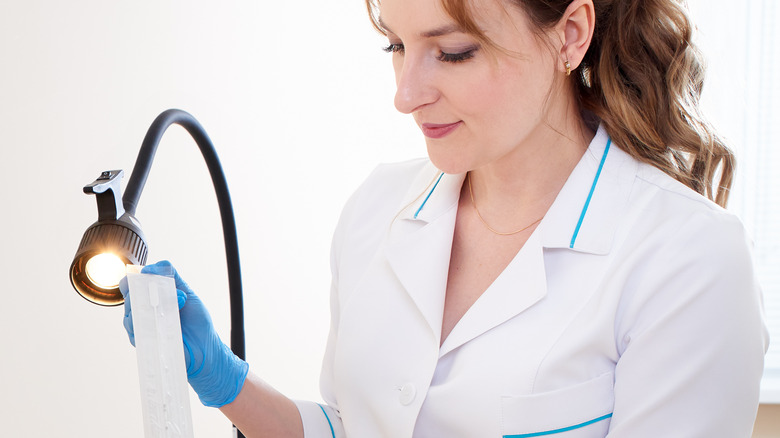 Health care professional preparing test